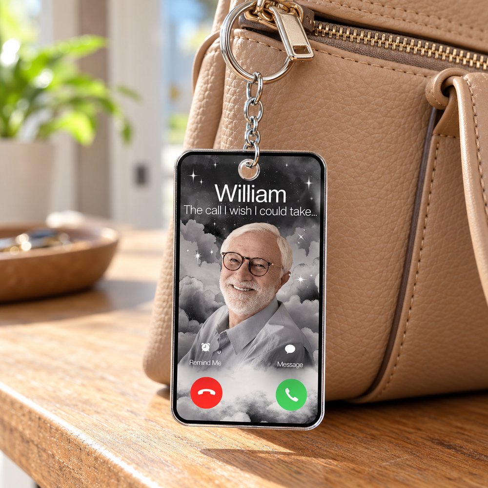 Personalized memorial photo acrylic keychain hanging on a leather handbag zipper in natural light