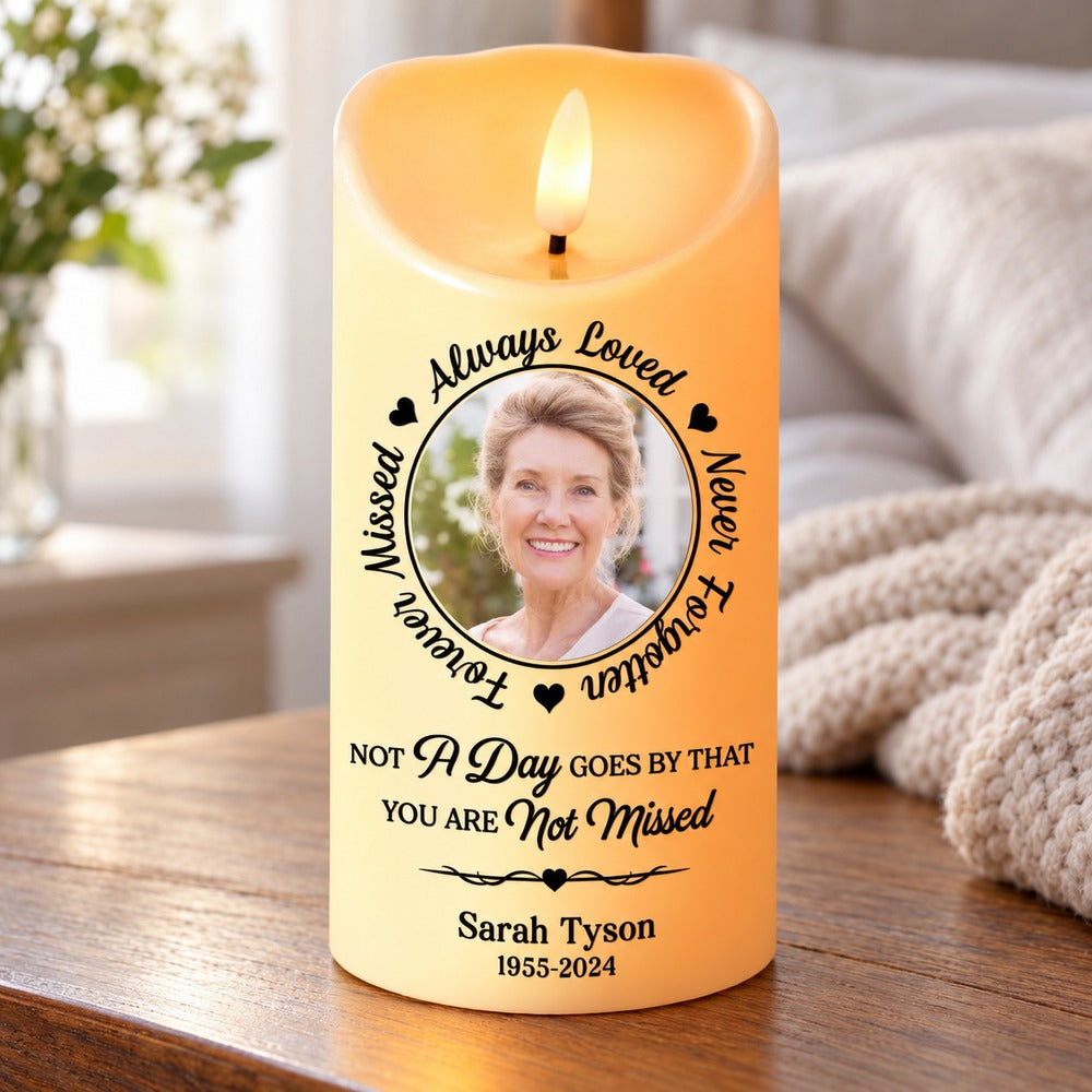 Custom photo sympathy LED candle glowing on a wooden bedside table