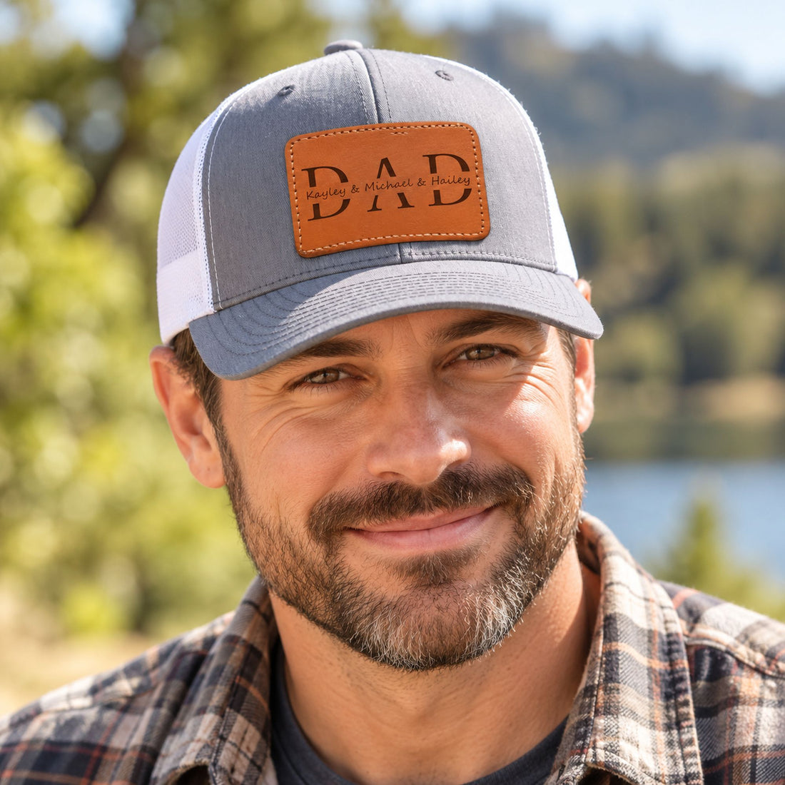 Father wearing personalized DAD leather patch trucker hat outdoors