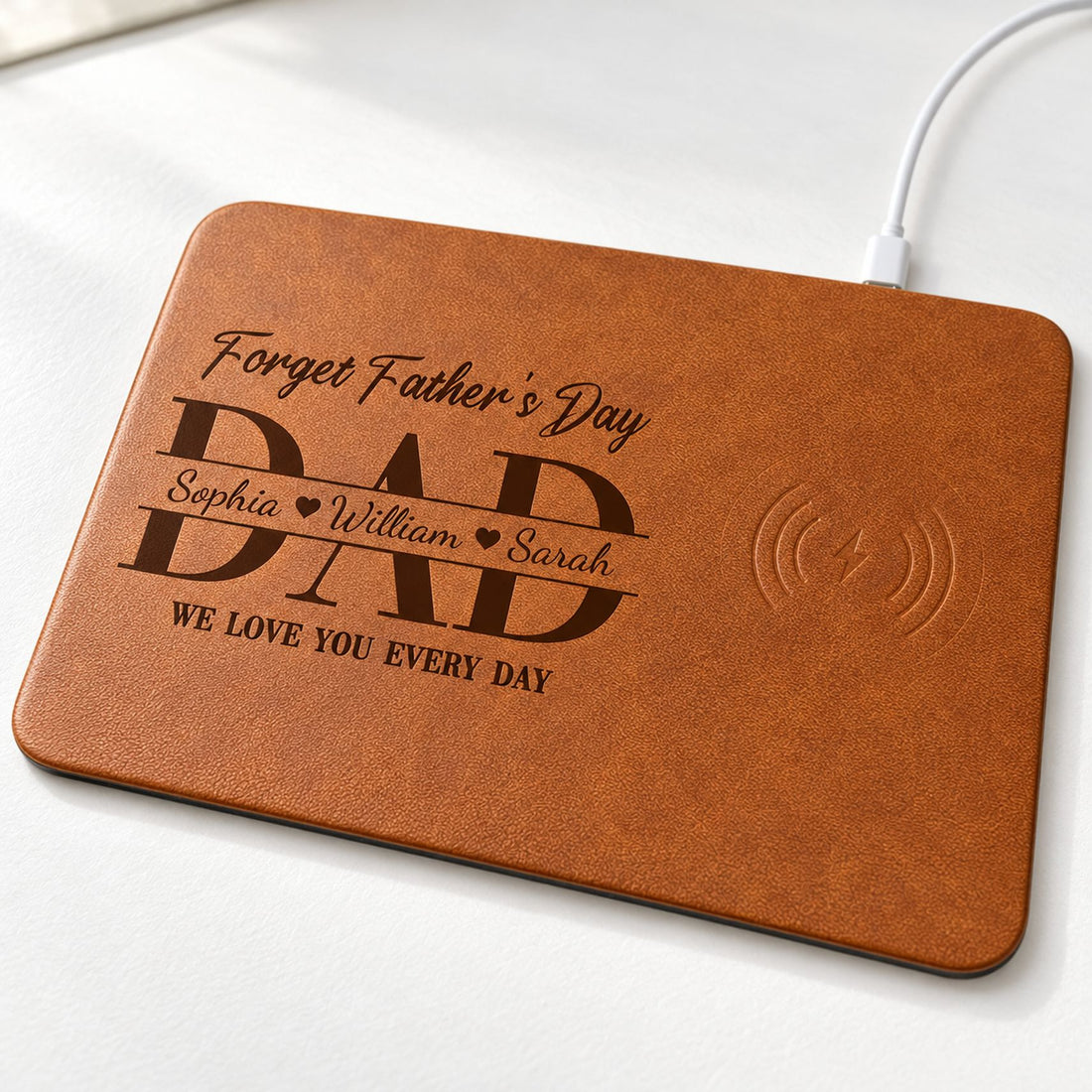 Close-up detail of the pebble-grain faux leather texture and personalized Dad print on the charging pad