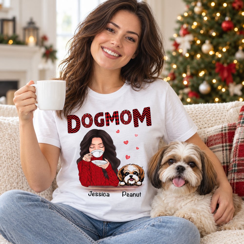Woman wearing personalized Dog Mom red patterned t-shirt on sofa with her dog at Christmas