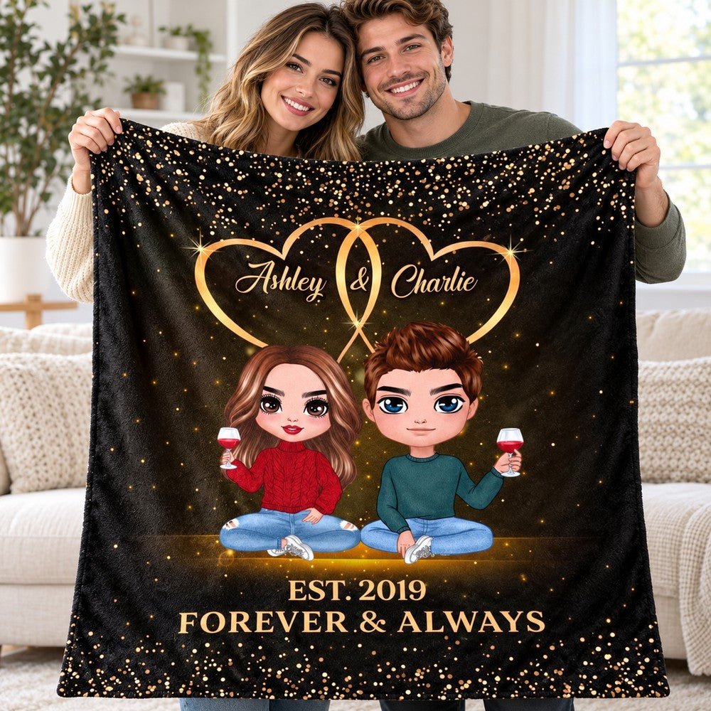 Happy couple holding their folded personalized anniversary blanket