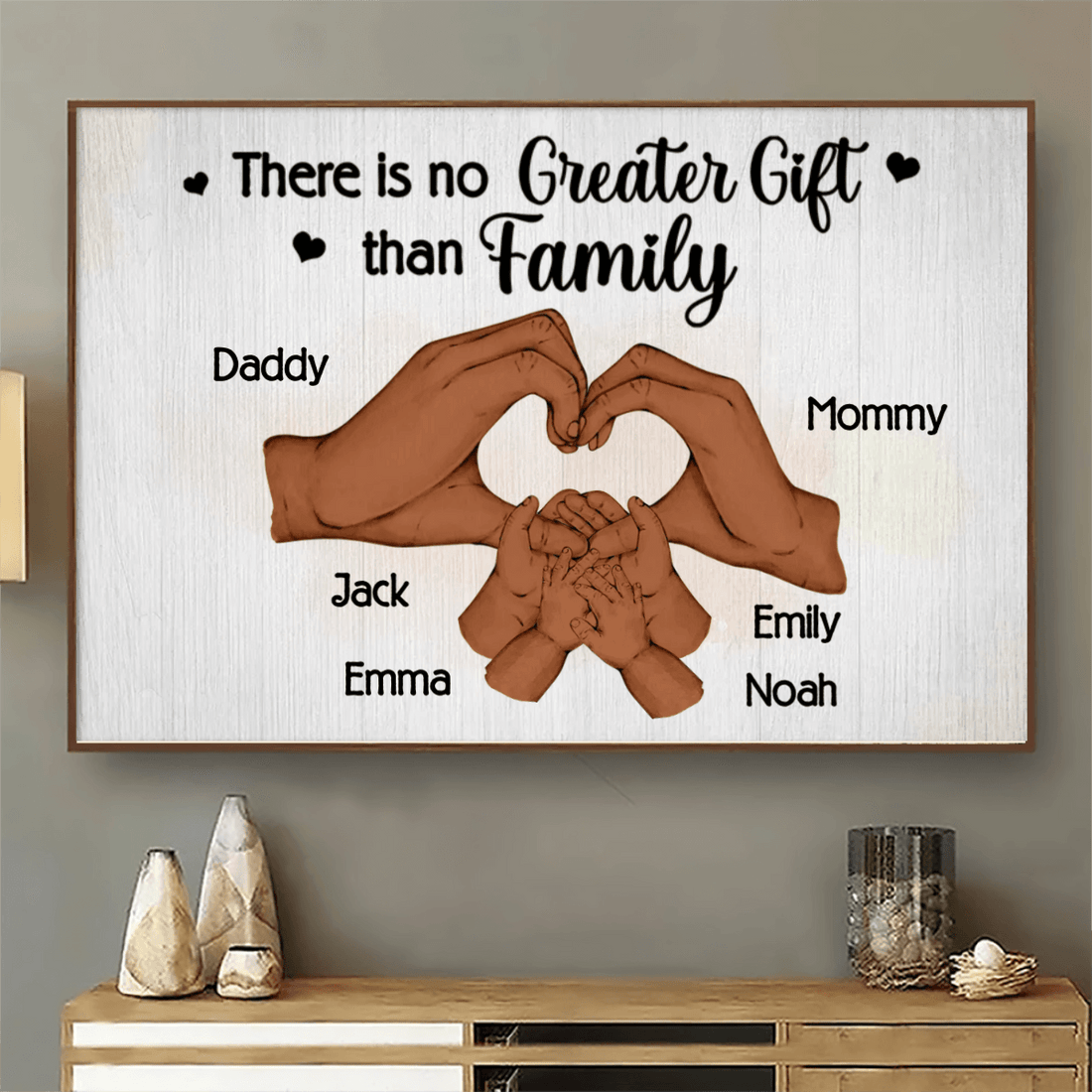 Personalized Family Hand Heart canvas print, a woman hanging the framed print on a wall