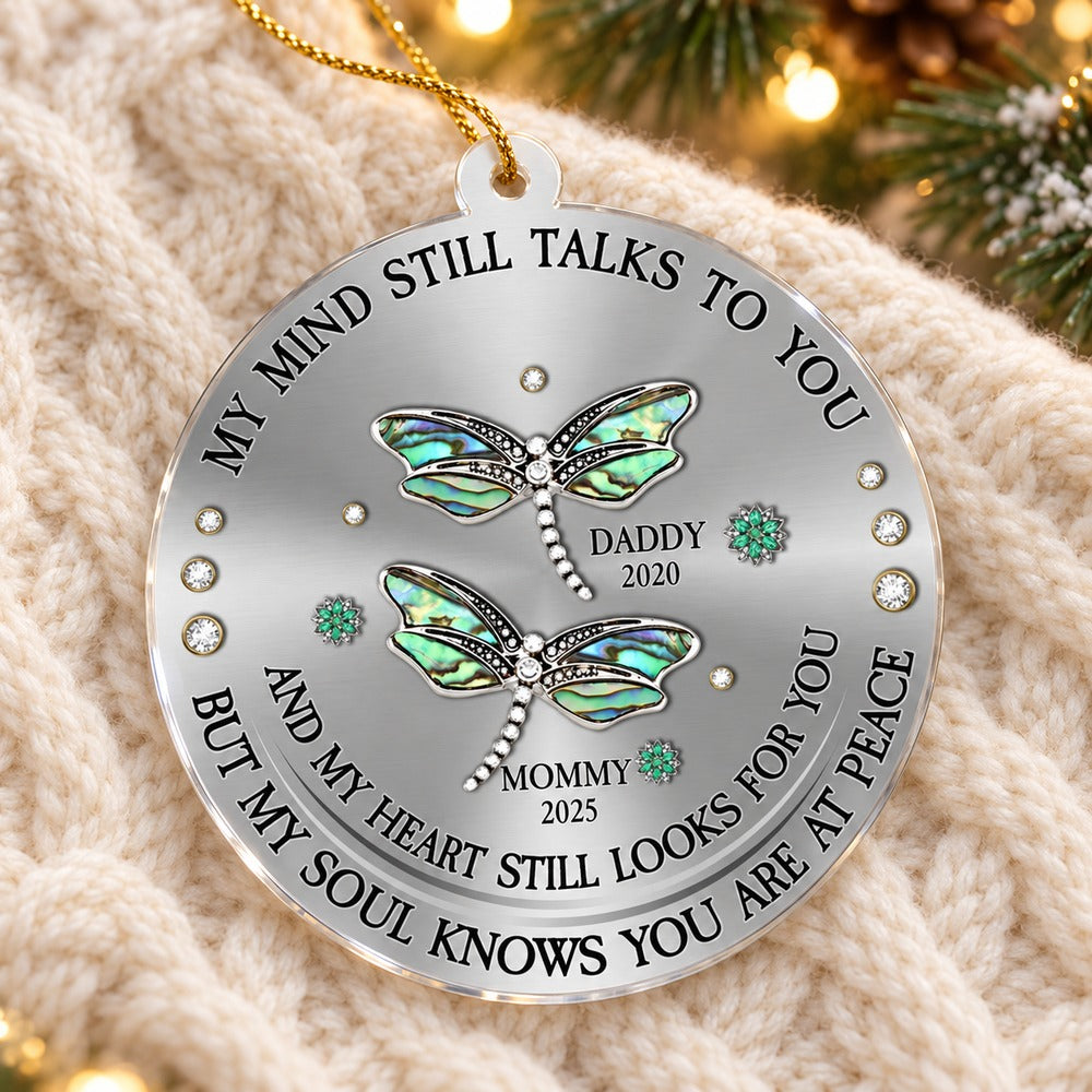 Personalized dragonfly sympathy acrylic ornament lying flat on a cozy cream knit blanket