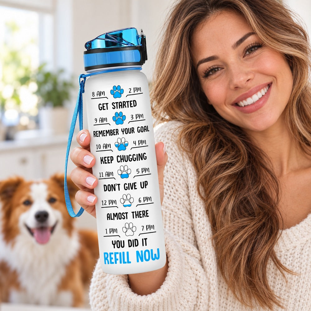 Dog lover holding personalized 32oz water tracker bottle showing paw print time markers
