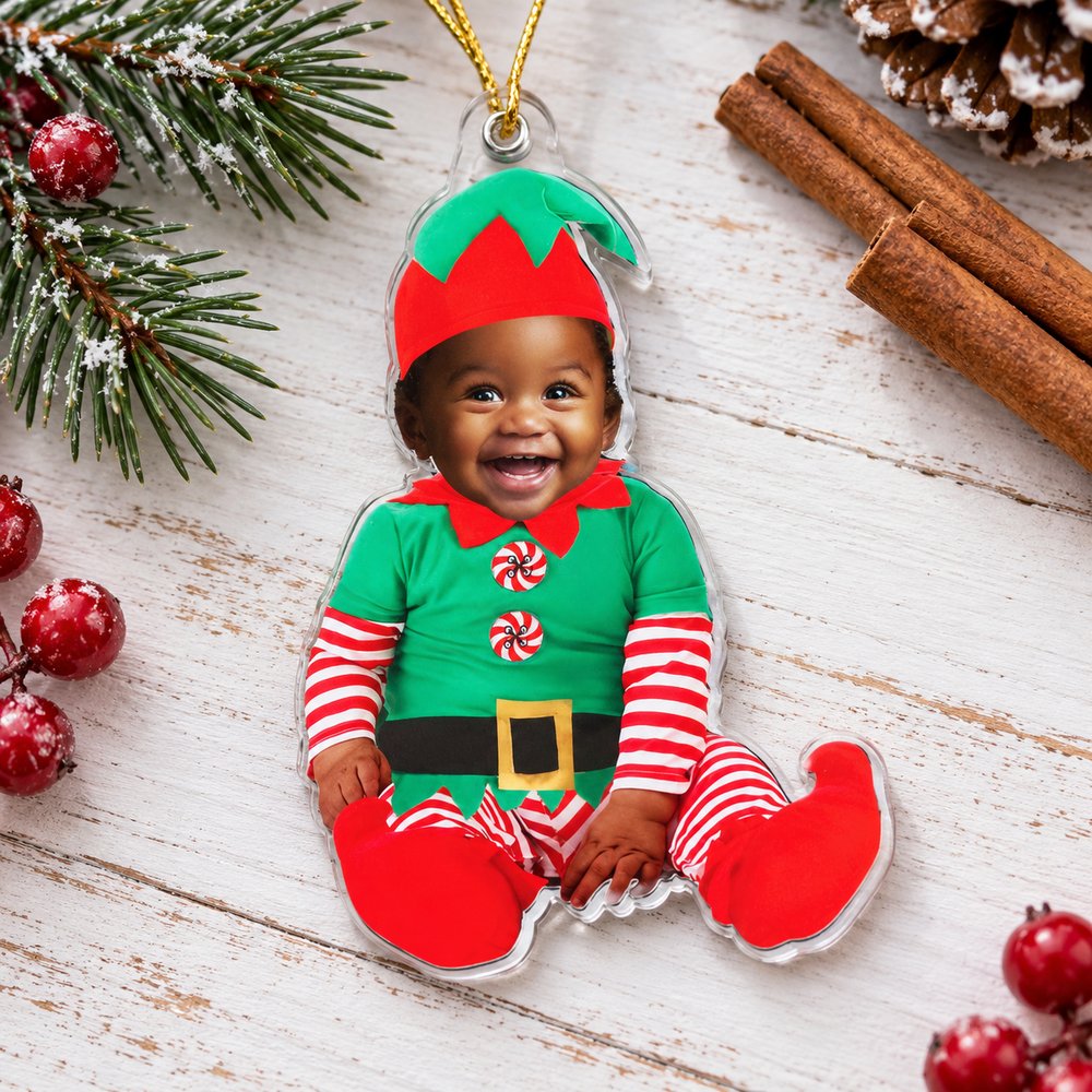 Personalized newborn baby elf acrylic ornament flat on festive holiday table