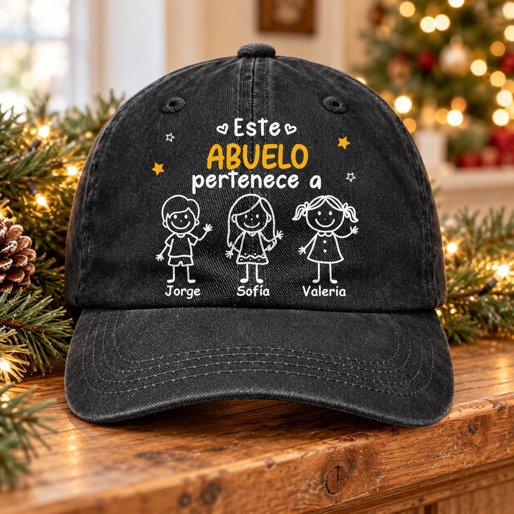 Personalized Este Abuelo Pertenece A denim cap on holiday mantel with pine garland