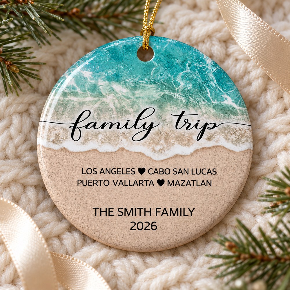 Personalized family trip beach ceramic ornament lying flat on a cozy cream knit surface