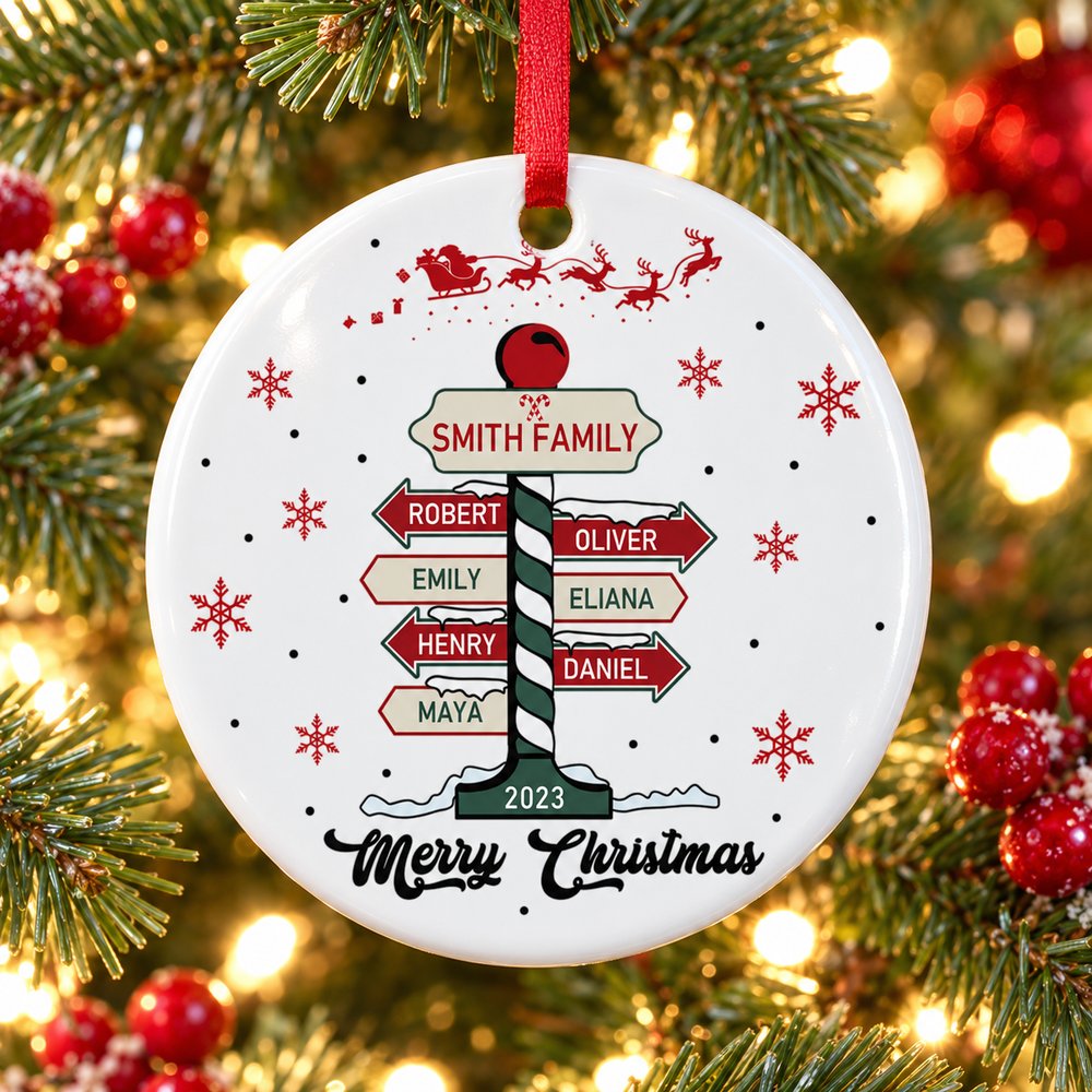 Personalized family signpost circle ceramic ornament hanging on a Christmas tree branch
