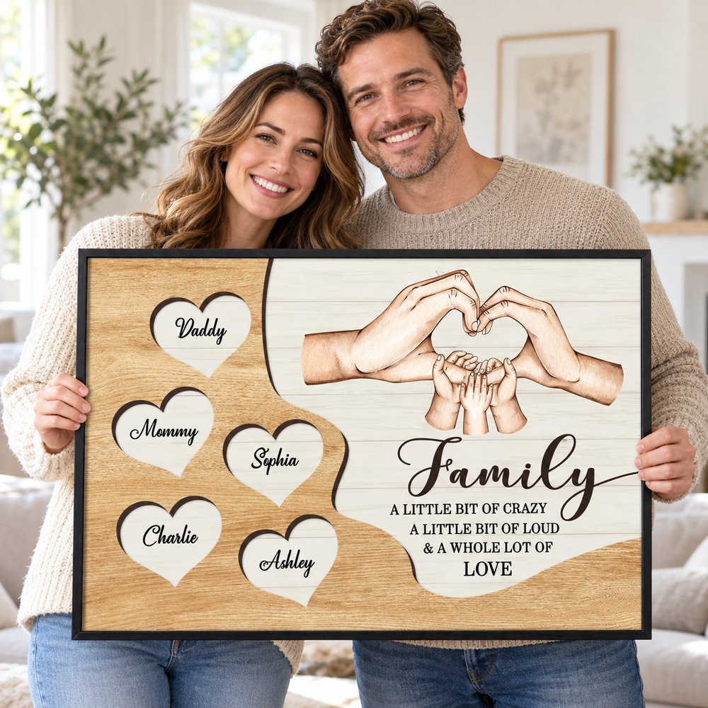 Mom and Dad happily holding their personalized Family Hands poster gift in a bright home