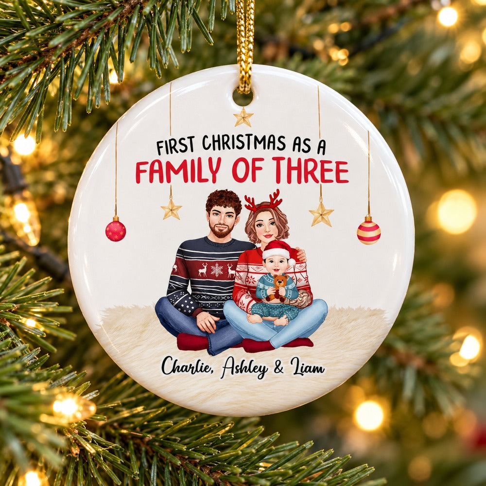 Personalized First Christmas As A Family Of Three circle ceramic ornament hanging on a Christmas tree branch