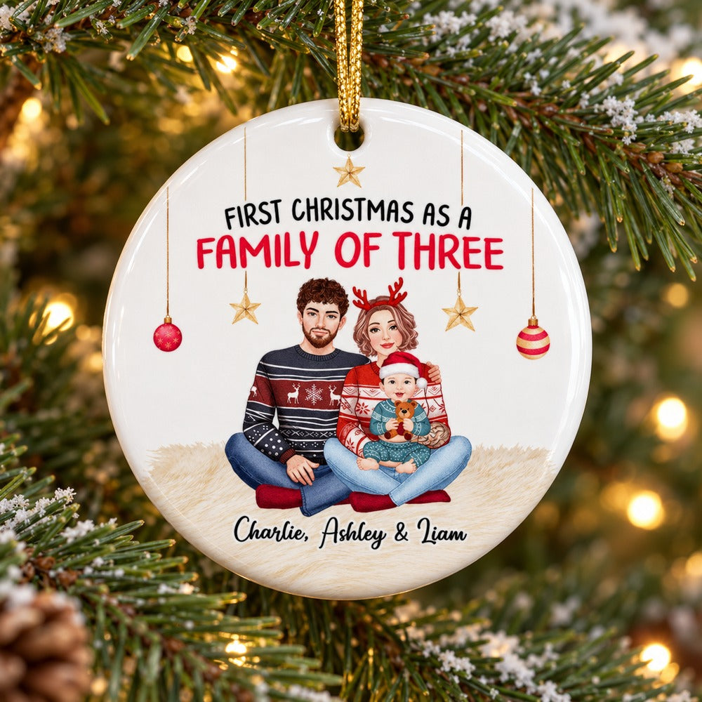 Close up detail of glossy ceramic surface and printed family illustration on First Christmas ornament