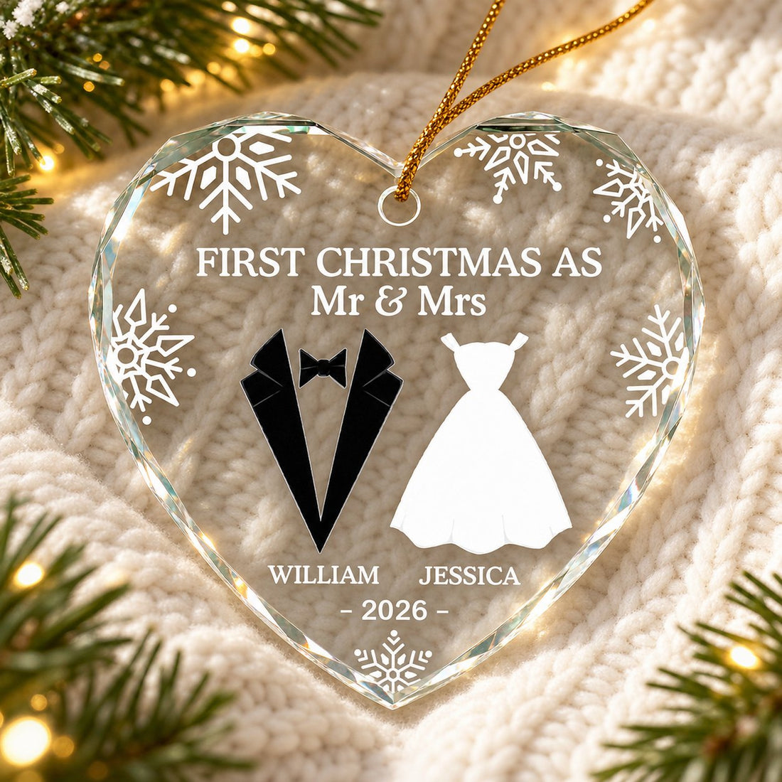 Personalized First Christmas As Mr and Mrs heart glass ornament lying on a cozy knit blanket with pine sprigs