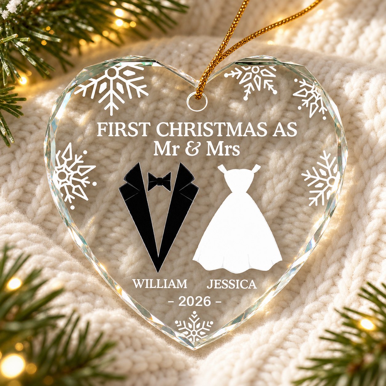 Personalized First Christmas As Mr and Mrs heart glass ornament lying on a cozy knit blanket with pine sprigs
