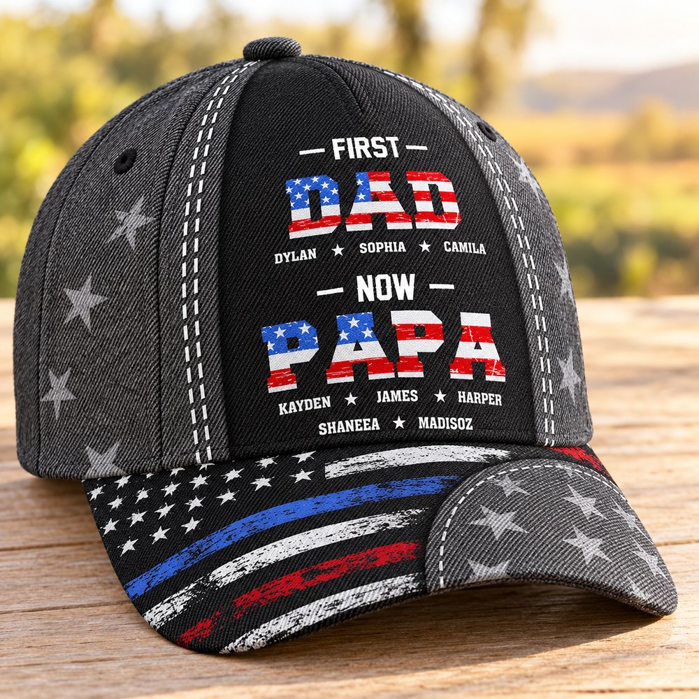 Close-up detail of First Dad Now Papa cap print texture and personalized names