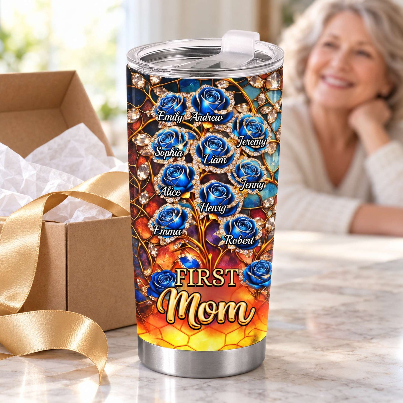 First Mom Now Grandma tumbler cup next to gift box and gold ribbon