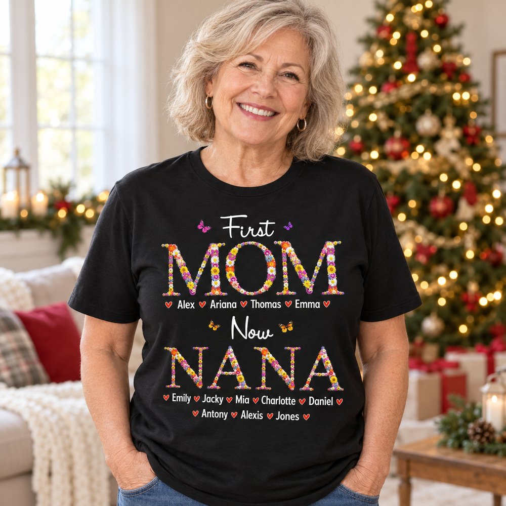 Grandma wearing personalized First Mom Now Nana floral pattern black t-shirt in a bright holiday living room