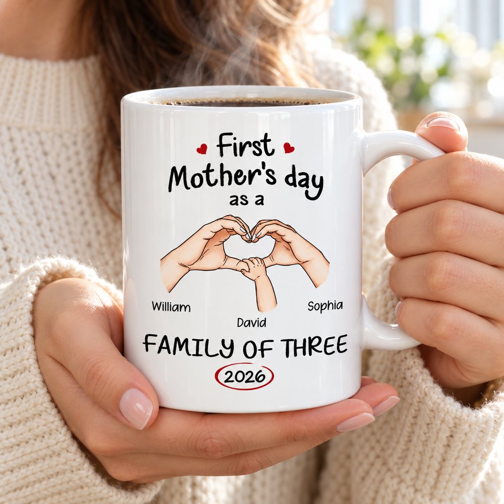 New mom holding personalized First Mother's Day Family of Three ceramic mug with hot coffee