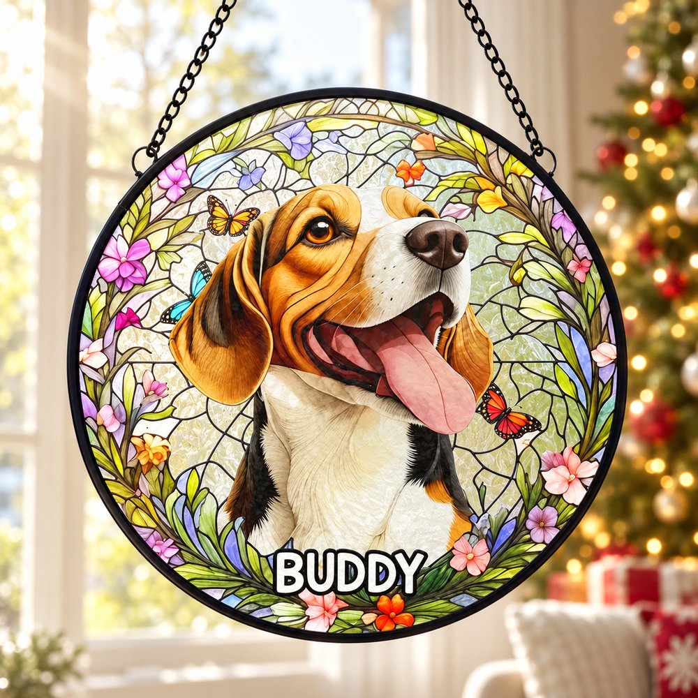 Personalized dog memorial stained glass suncatcher hanging in a bright window with holiday tree in background