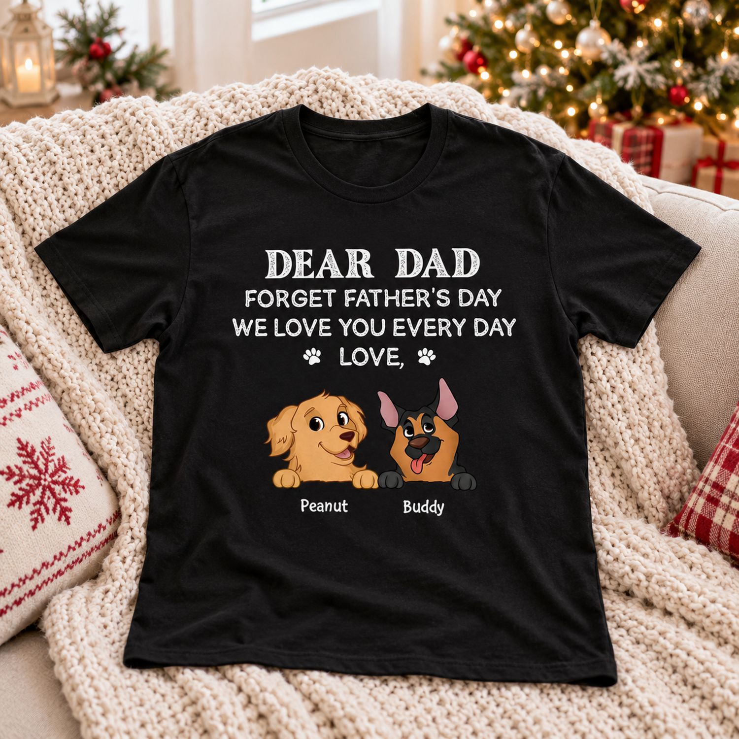 Personalized Dog Dad black t-shirt laid on a cozy blanket near a Christmas tree for holiday gifting