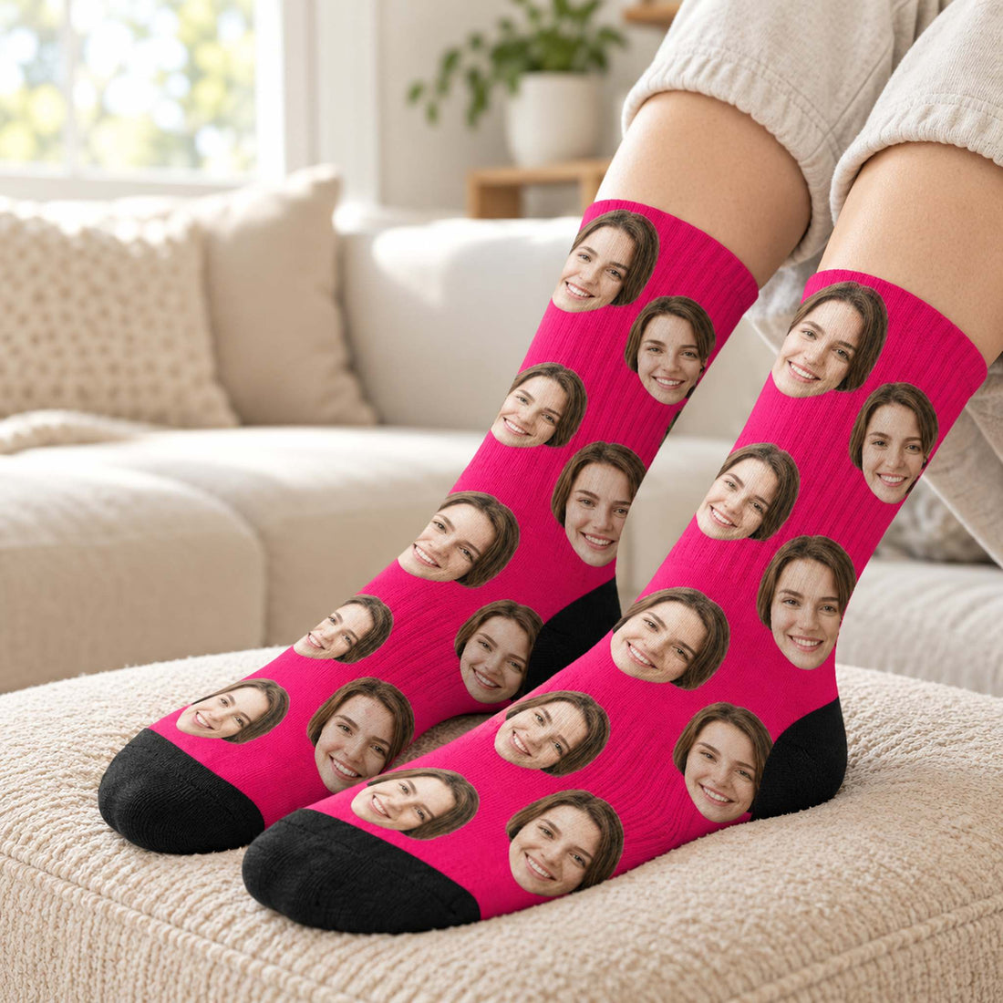 Person wearing hot pink custom girlfriend face crew socks on a cozy beige ottoman