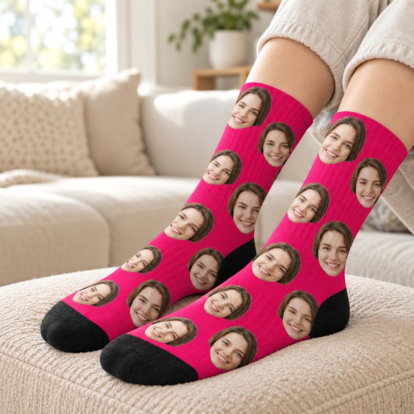 Person wearing hot pink custom girlfriend face crew socks on a cozy beige ottoman