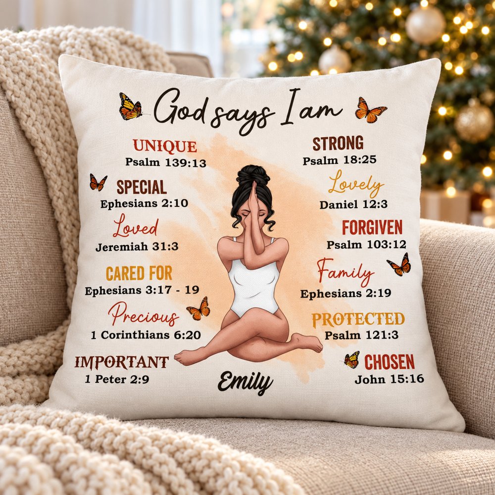 God Says I Am personalized pillow on a cozy sofa with holiday lights in the background