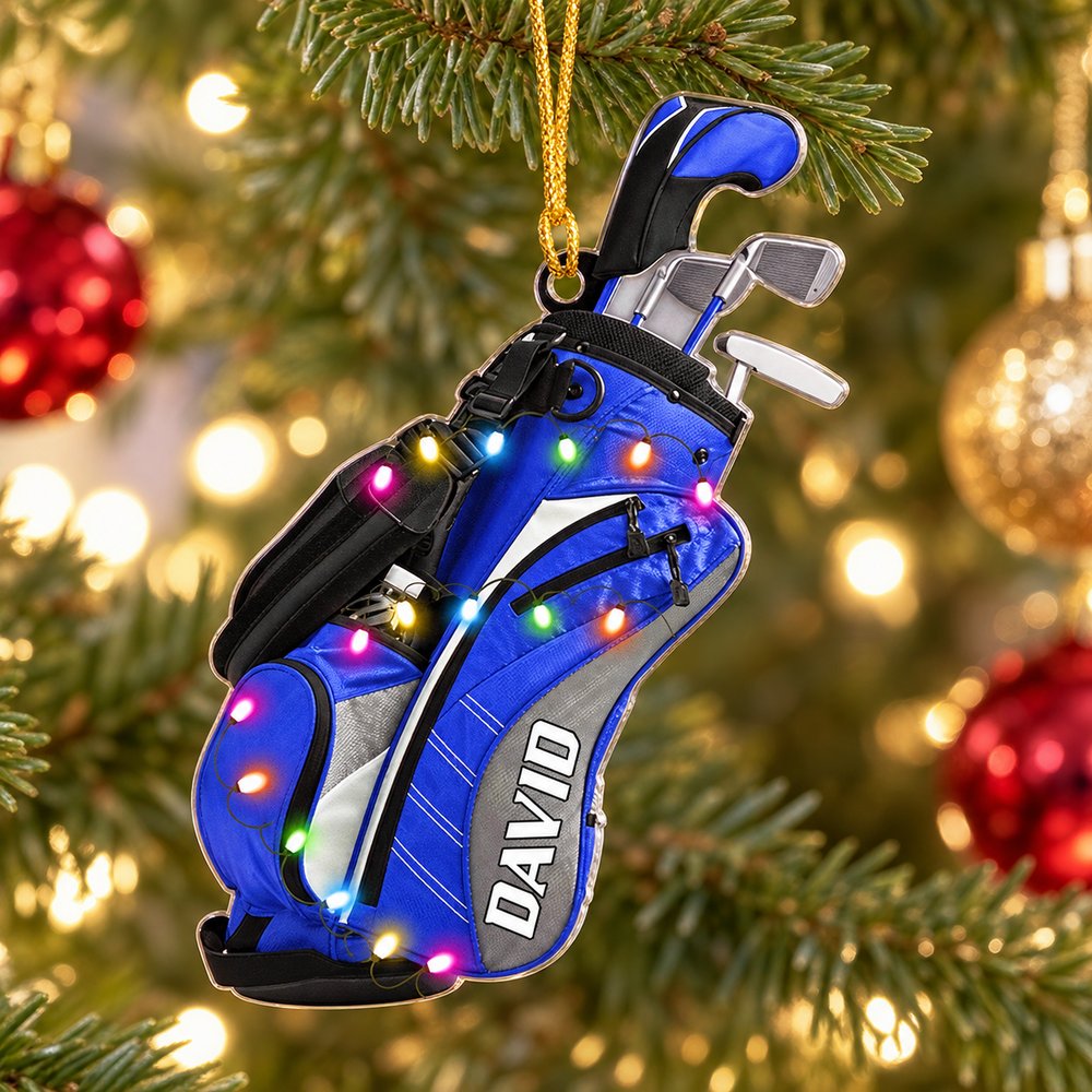 Personalized golf bag acrylic ornament hanging on a Christmas tree branch with festive lights