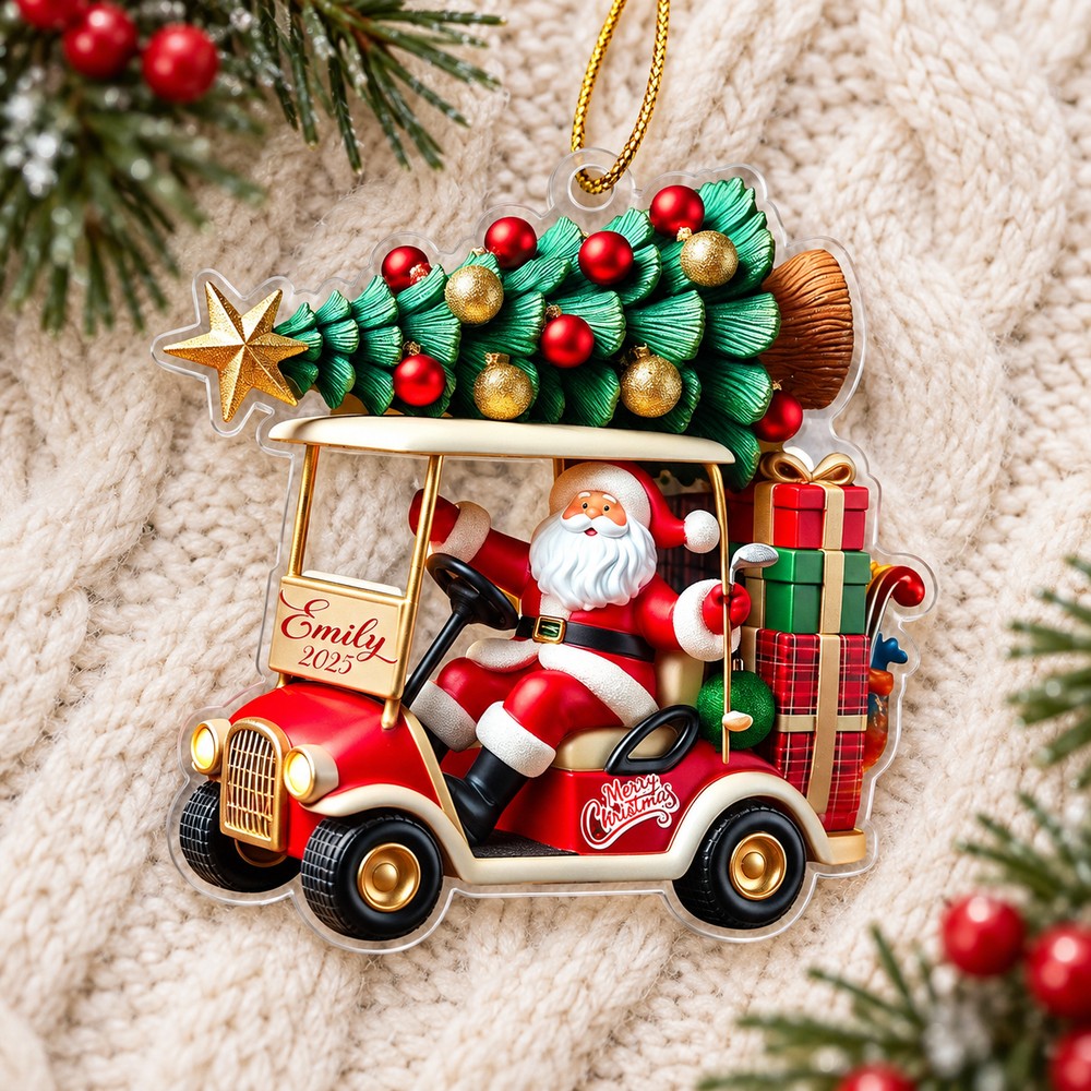 Personalized Santa golf cart acrylic ornament lying flat on a cream knit blanket with pine greenery