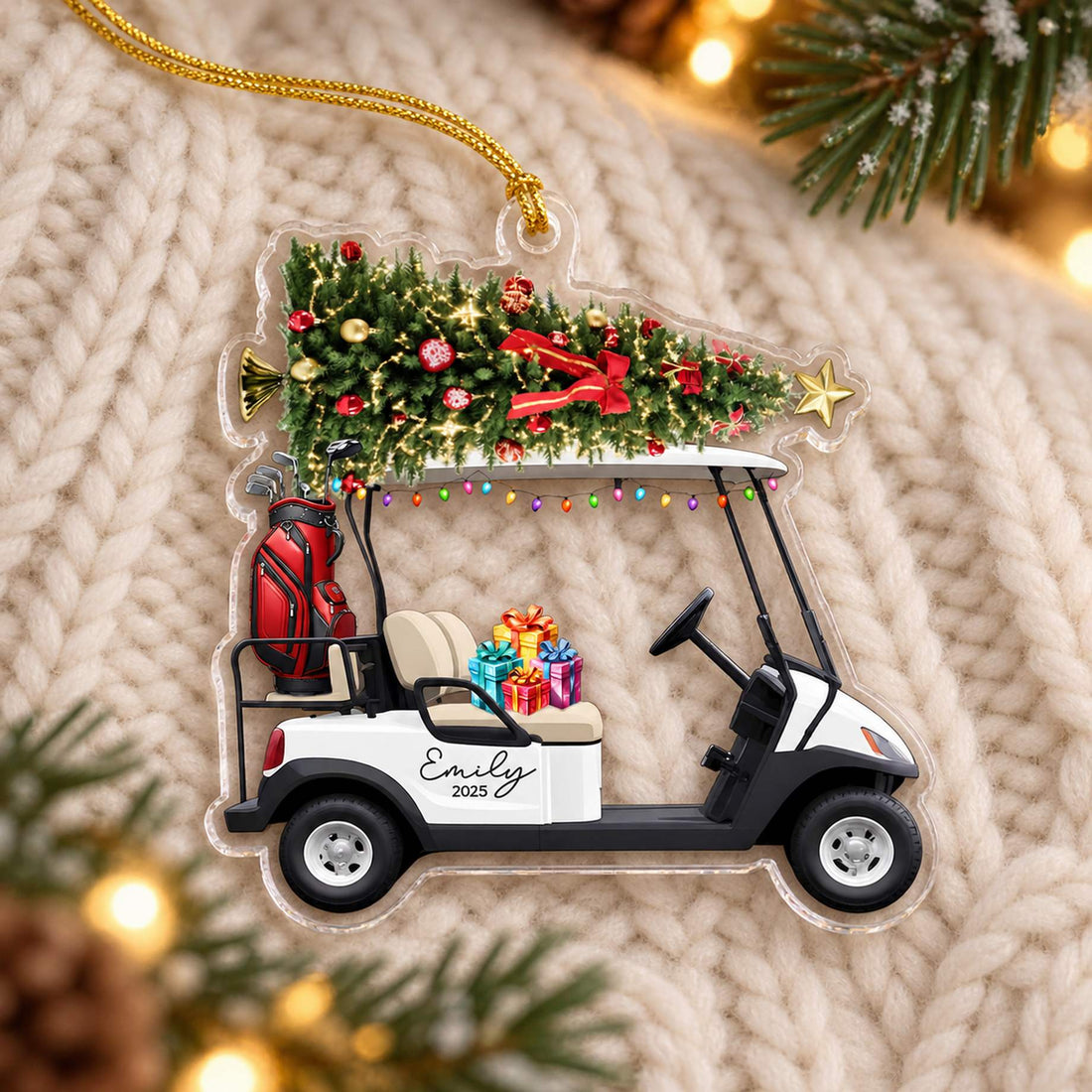Custom shaped golf cart acrylic ornament lying flat on cream knit fabric with holiday greenery