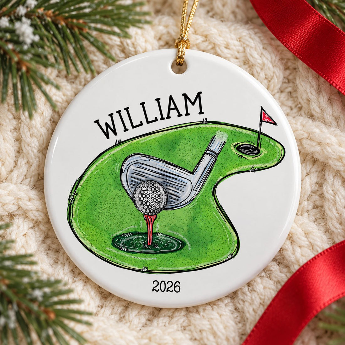 Custom golf ceramic ornament lying flat on a cream knit throw with pine greenery