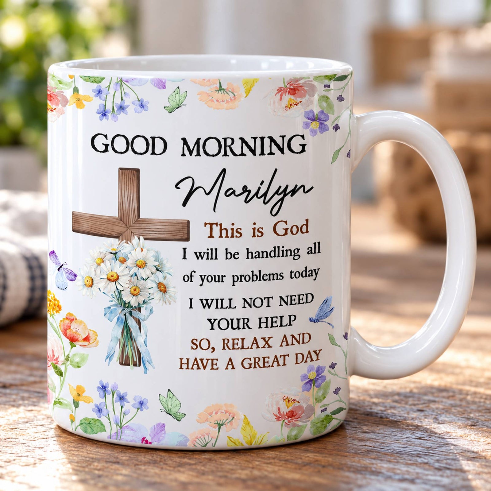 Close-up detail of wooden cross daisy bouquet and Marilyn script on the glossy ceramic mug