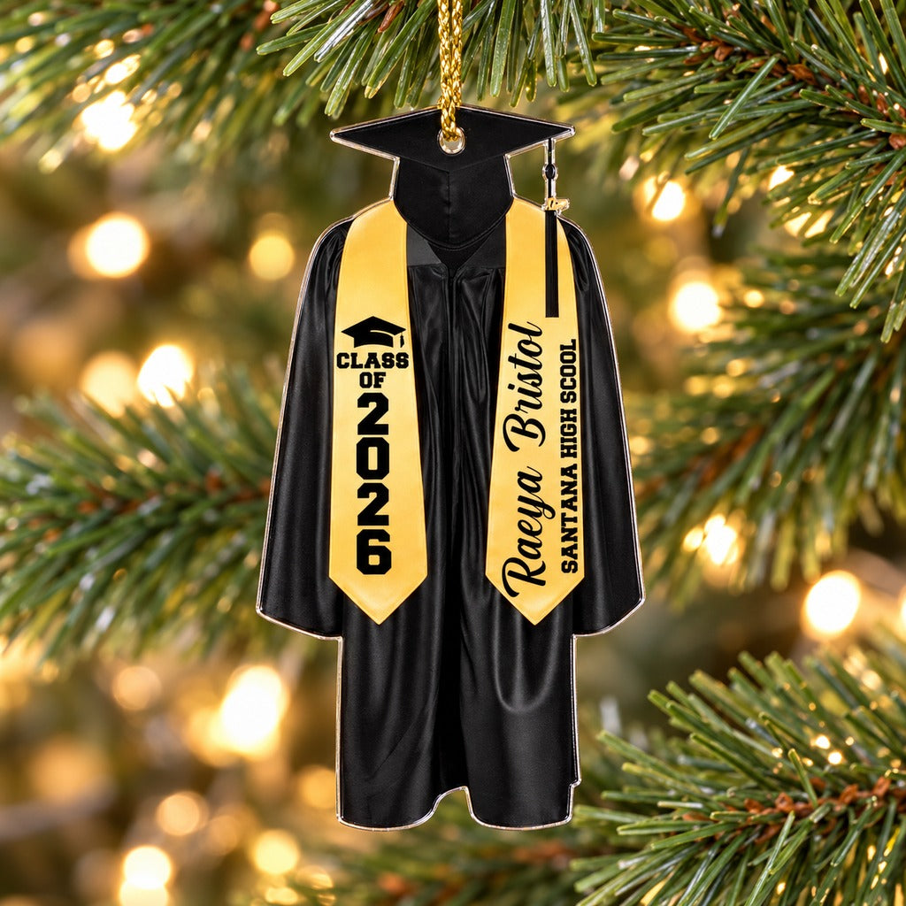 Personalized black graduation cap and gown acrylic ornament hanging on a Christmas tree branch