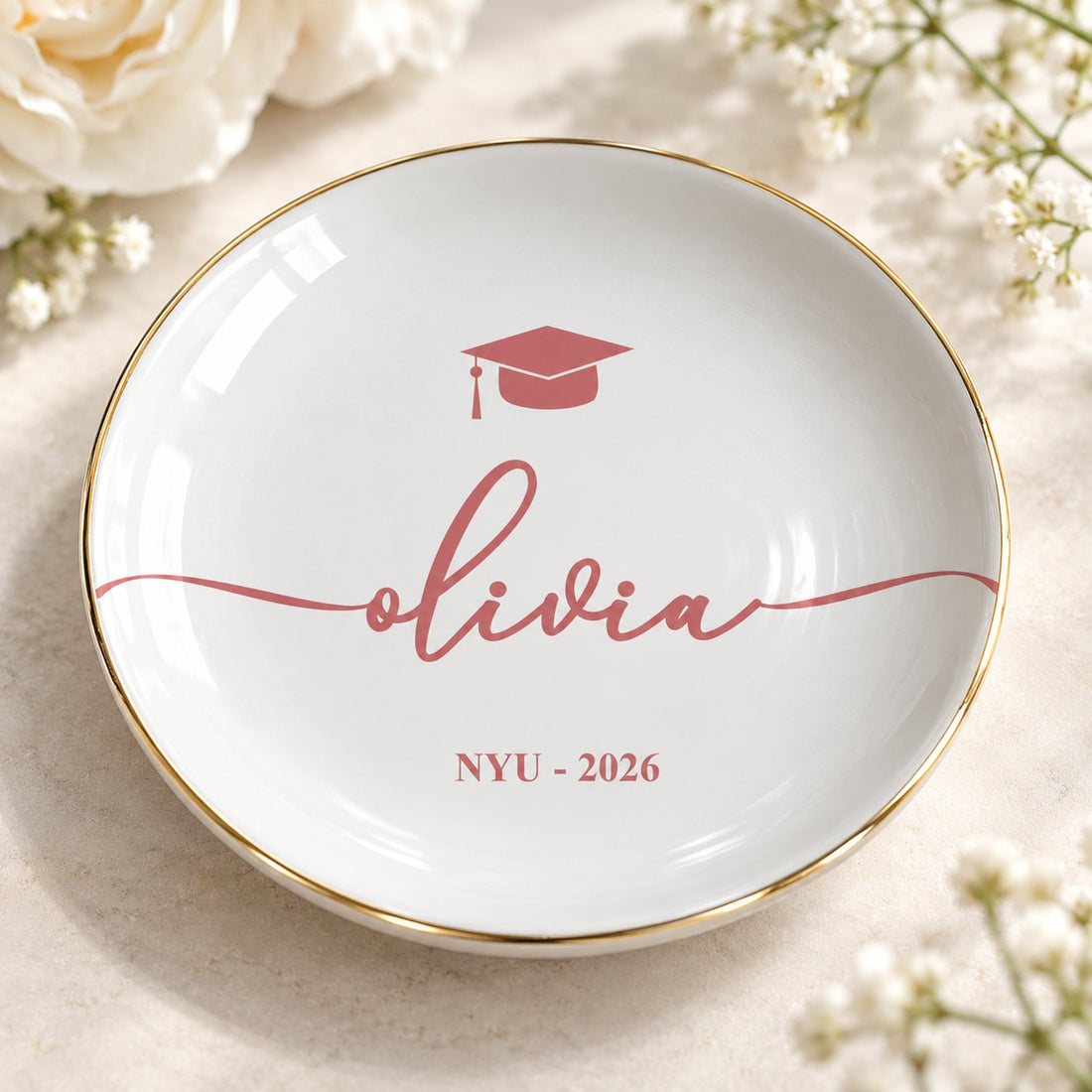 Macro closeup of glossy ceramic graduation jewelry dish print and metallic gold rim