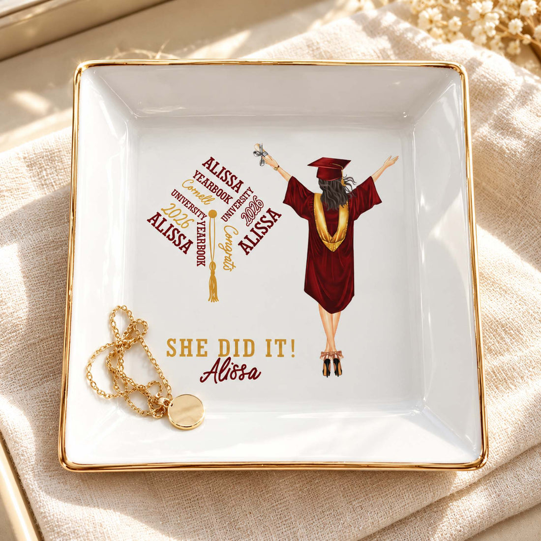 Personalized She Did It graduation jewelry dish holding a gold necklace on a vanity