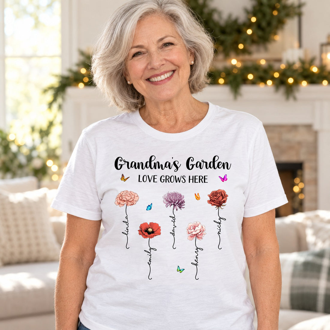 Grandma wearing personalized Grandmas Garden birth month flower white t-shirt in a bright holiday living room