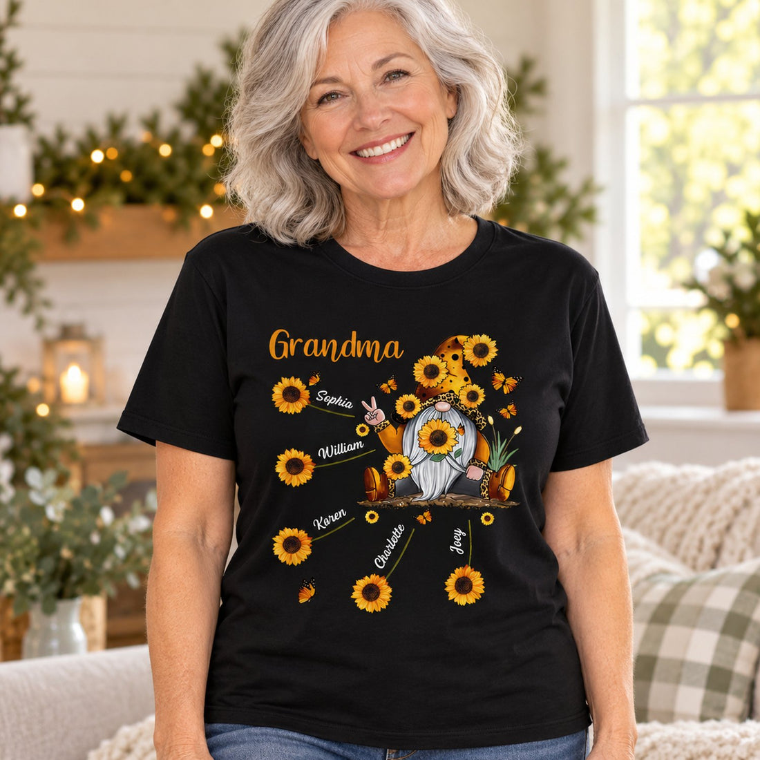 Grandma wearing personalized black sunflower gnome t-shirt with grandkids names in bright holiday living room