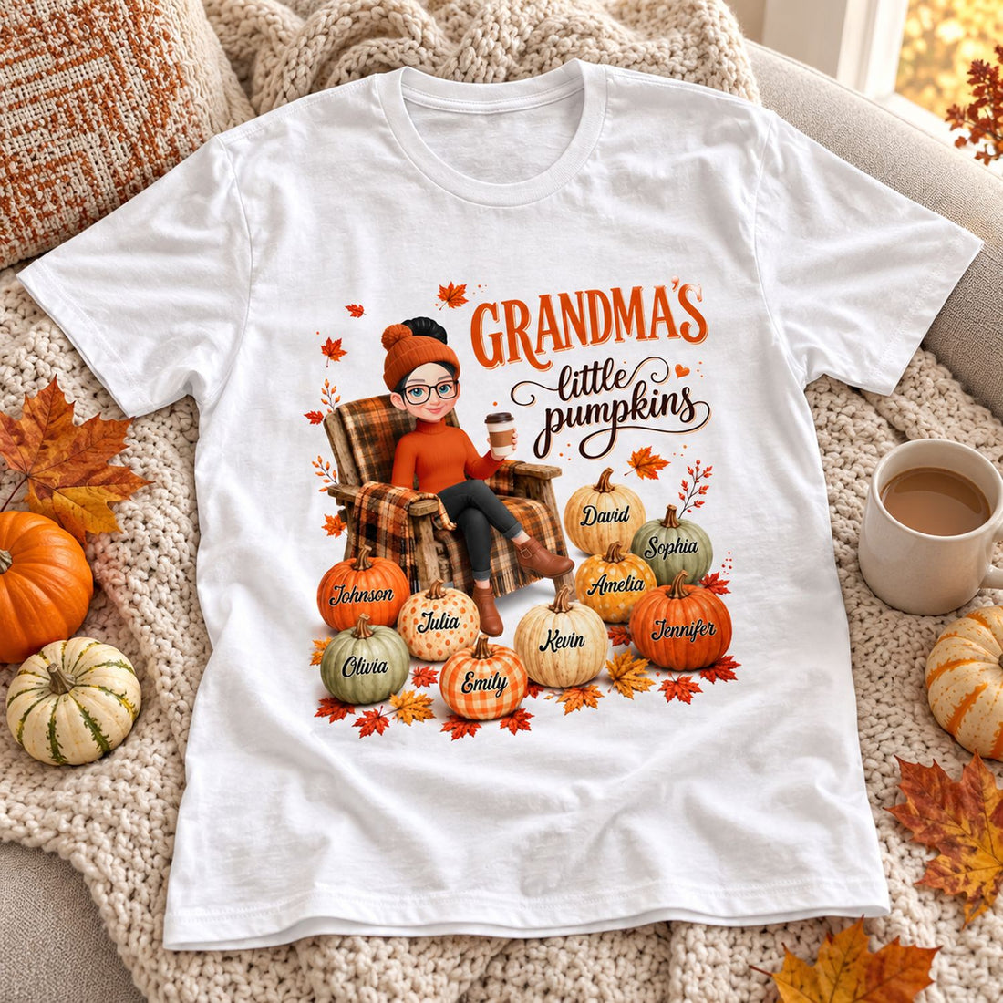 Personalized Grandmas Little Pumpkins white t-shirt styled on a cozy sofa with fall leaves and mini pumpkins