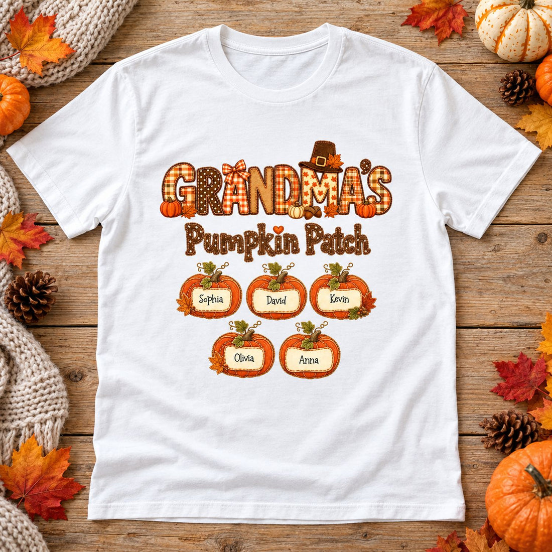 Personalized Grandma's Pumpkin Patch t-shirt laid flat with autumn leaves and harvest pumpkins