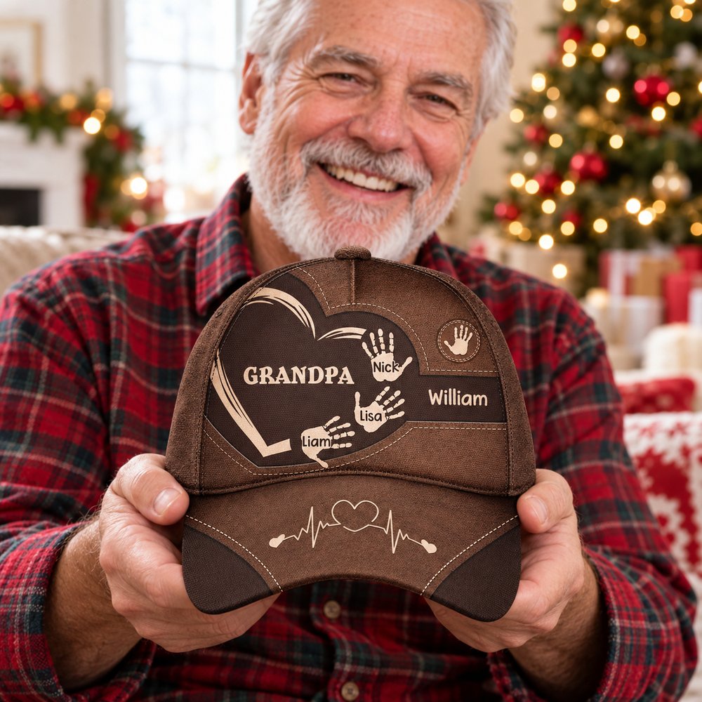 Grandpa holding personalized kids handprints brown classic cap on Christmas morning