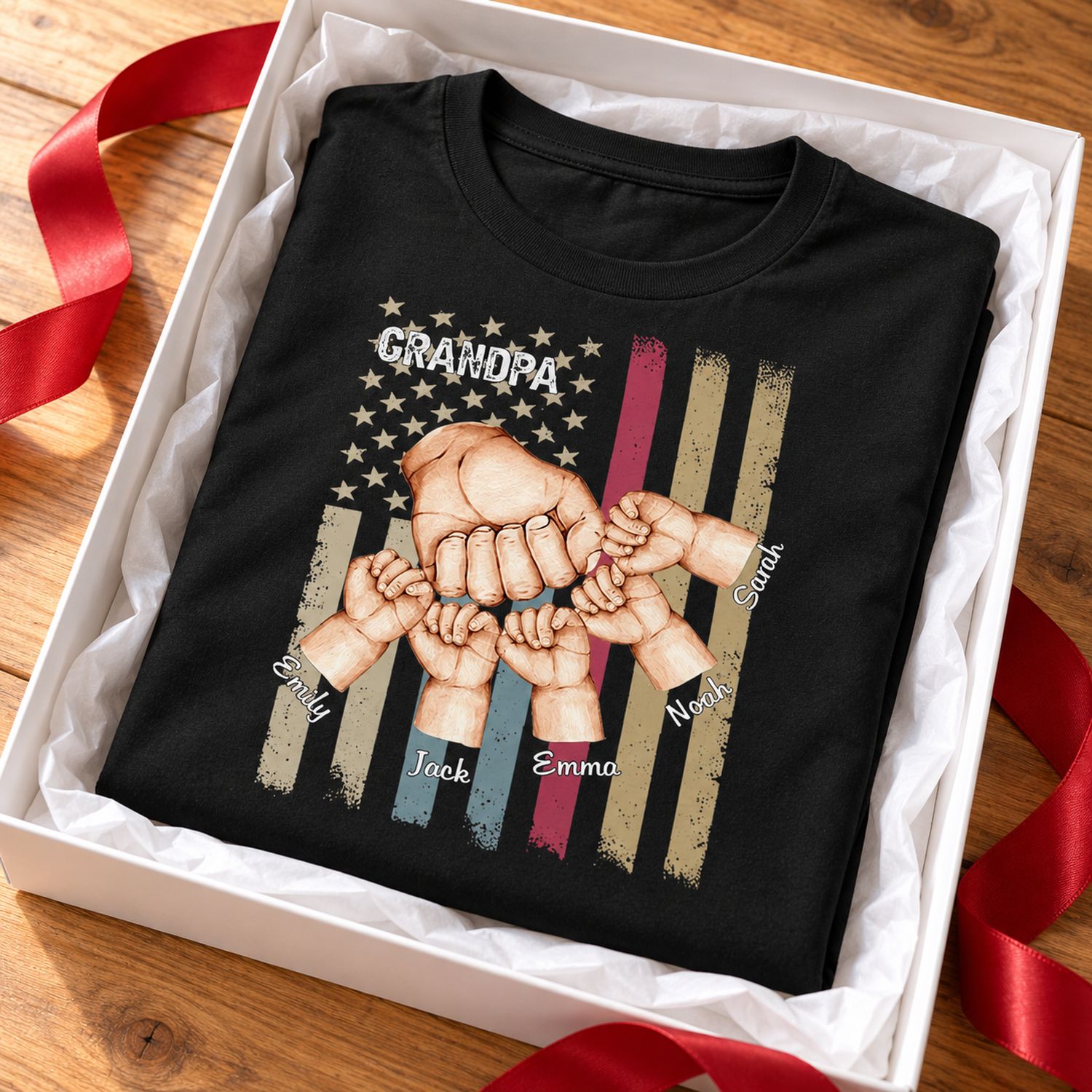 Personalized Grandpa Fist Bump t-shirt folded in a holiday gift box with red ribbon