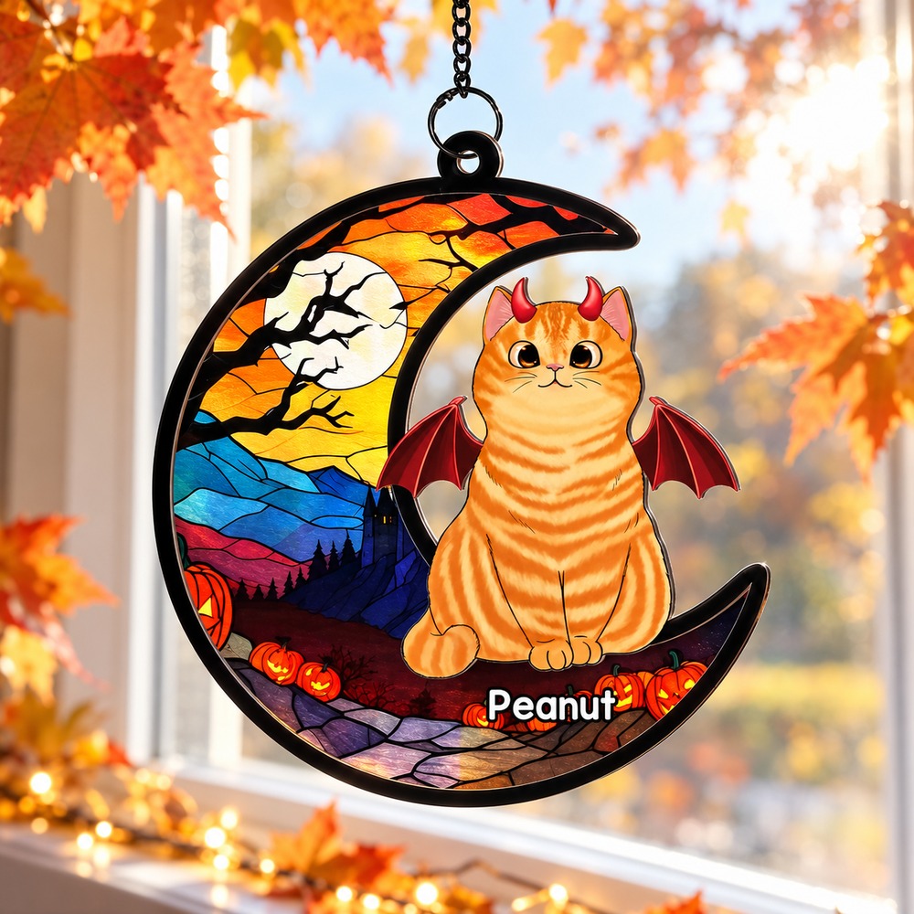 Halloween Cat On Moon personalized suncatcher ornament hanging in a sunlit autumn window