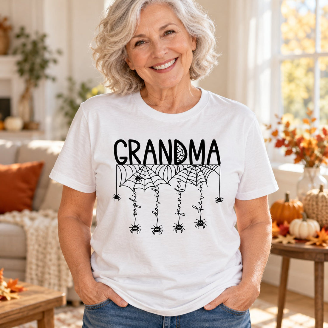Grandma wearing personalized Halloween spiderweb t-shirt with grandkids names in autumn living room