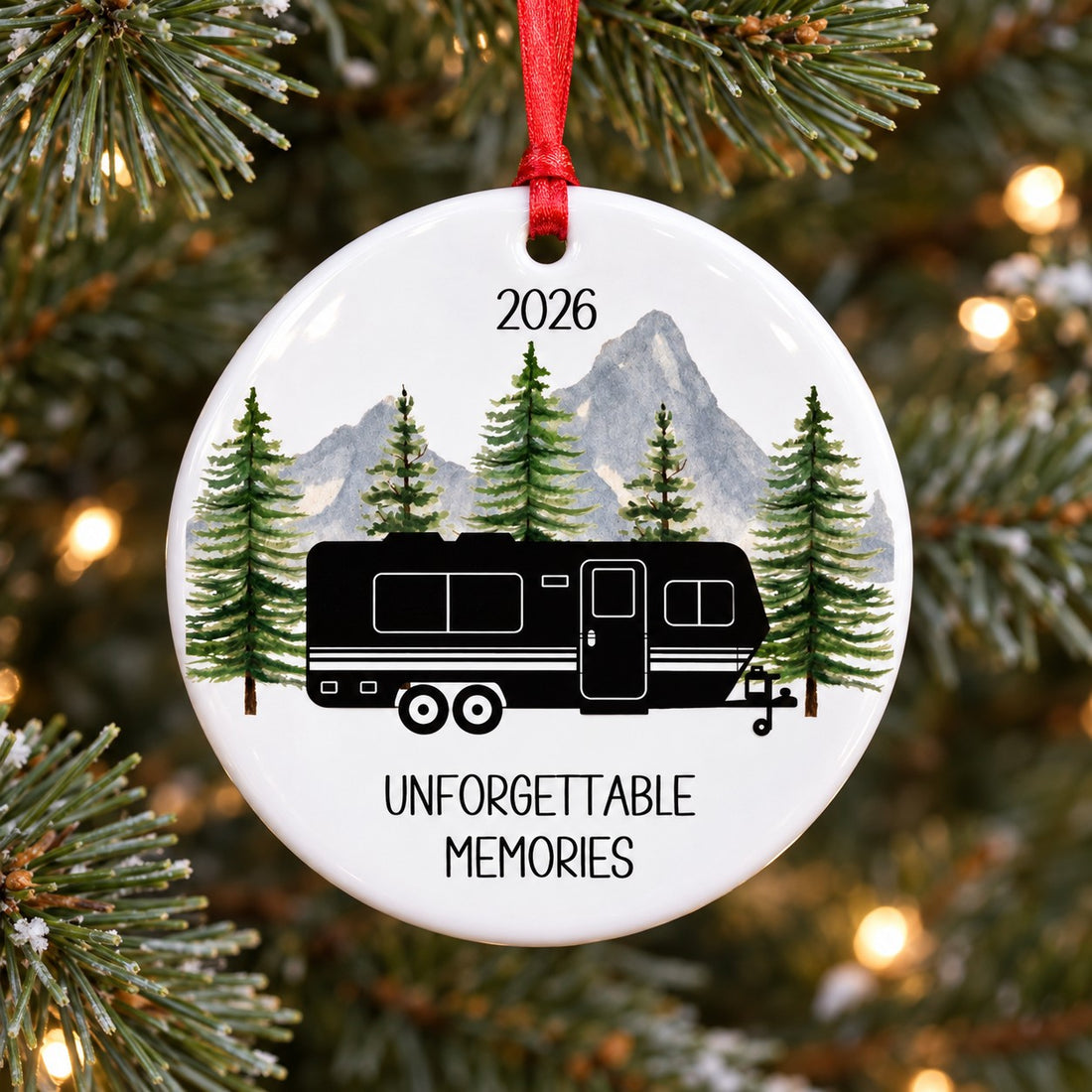 Close-up detail of glossy ceramic RV ornament showing watercolor pines and Unforgettable Memories print