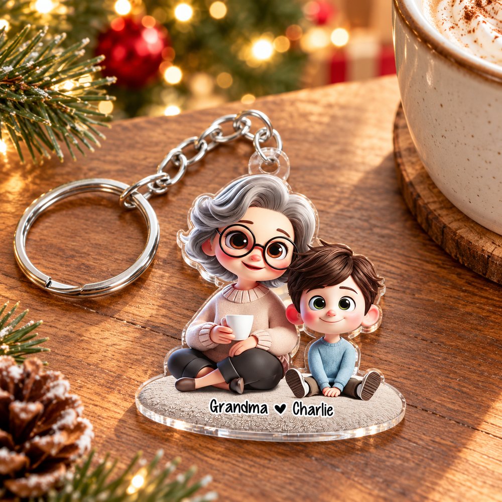Grandma and Grandkid personalized acrylic keychain lying flat on a holiday table near pine branches