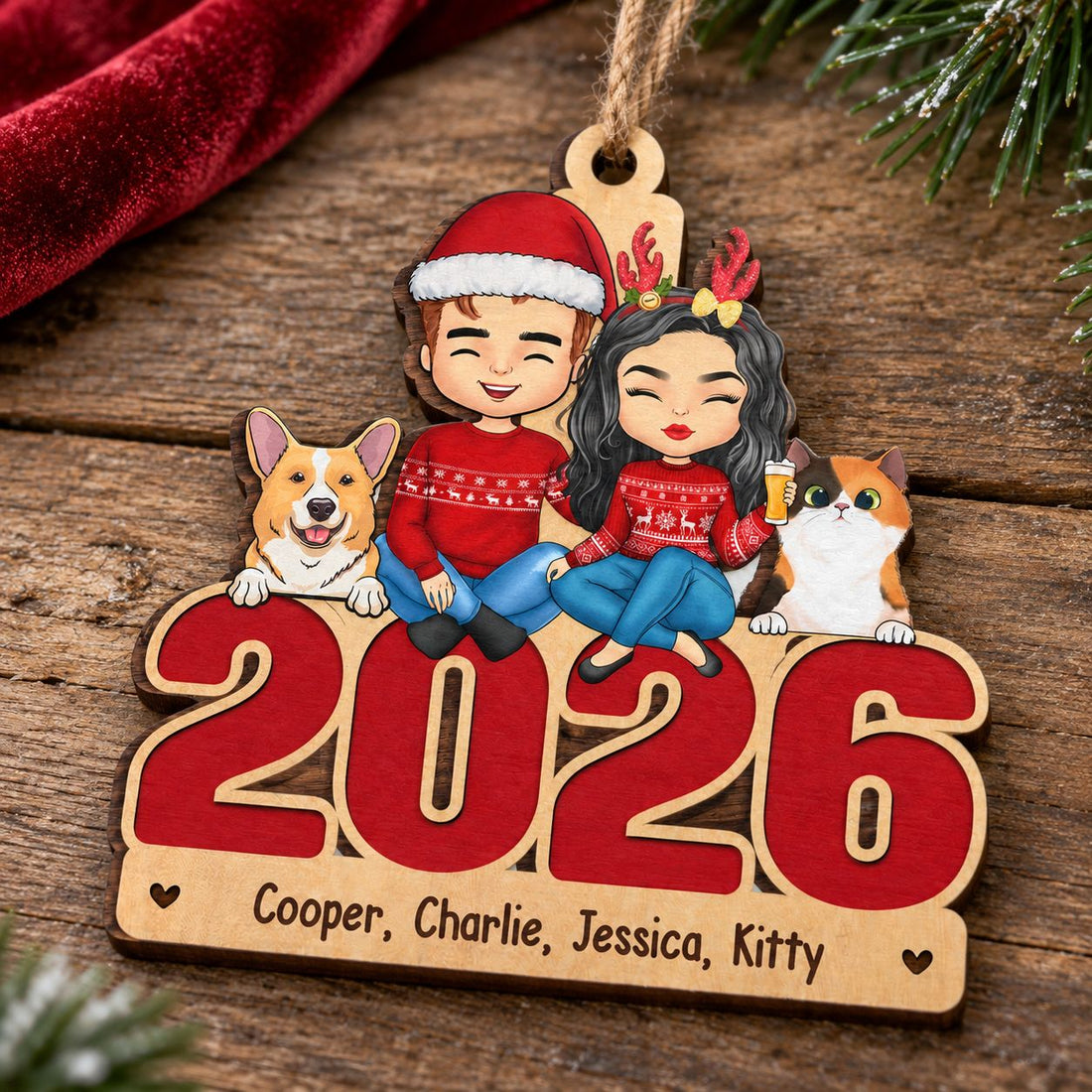 Personalized 2026 family dog and cat wood ornament resting flat on a rustic wooden surface