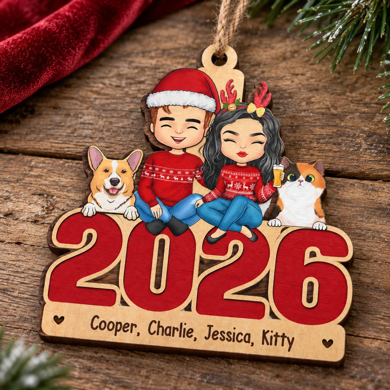 Personalized 2026 family dog and cat wood ornament resting flat on a rustic wooden surface