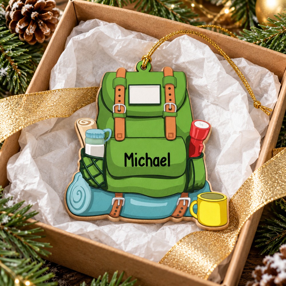Personalized hiker backpack wood ornament nestled in a white tissue-lined gift box for Christmas