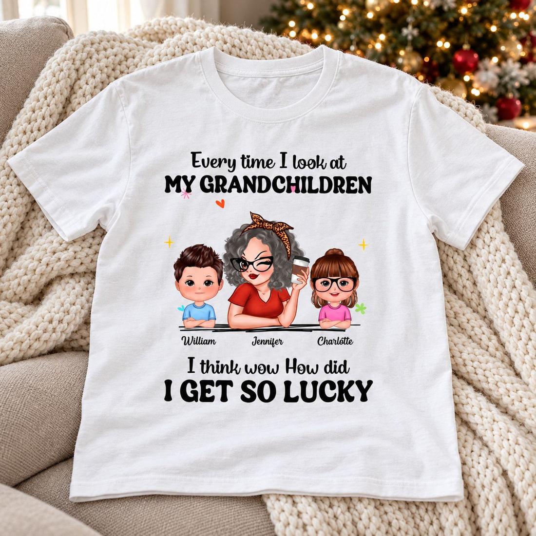 Personalized Grandma t-shirt laid flat on a cozy sofa near a Christmas tree