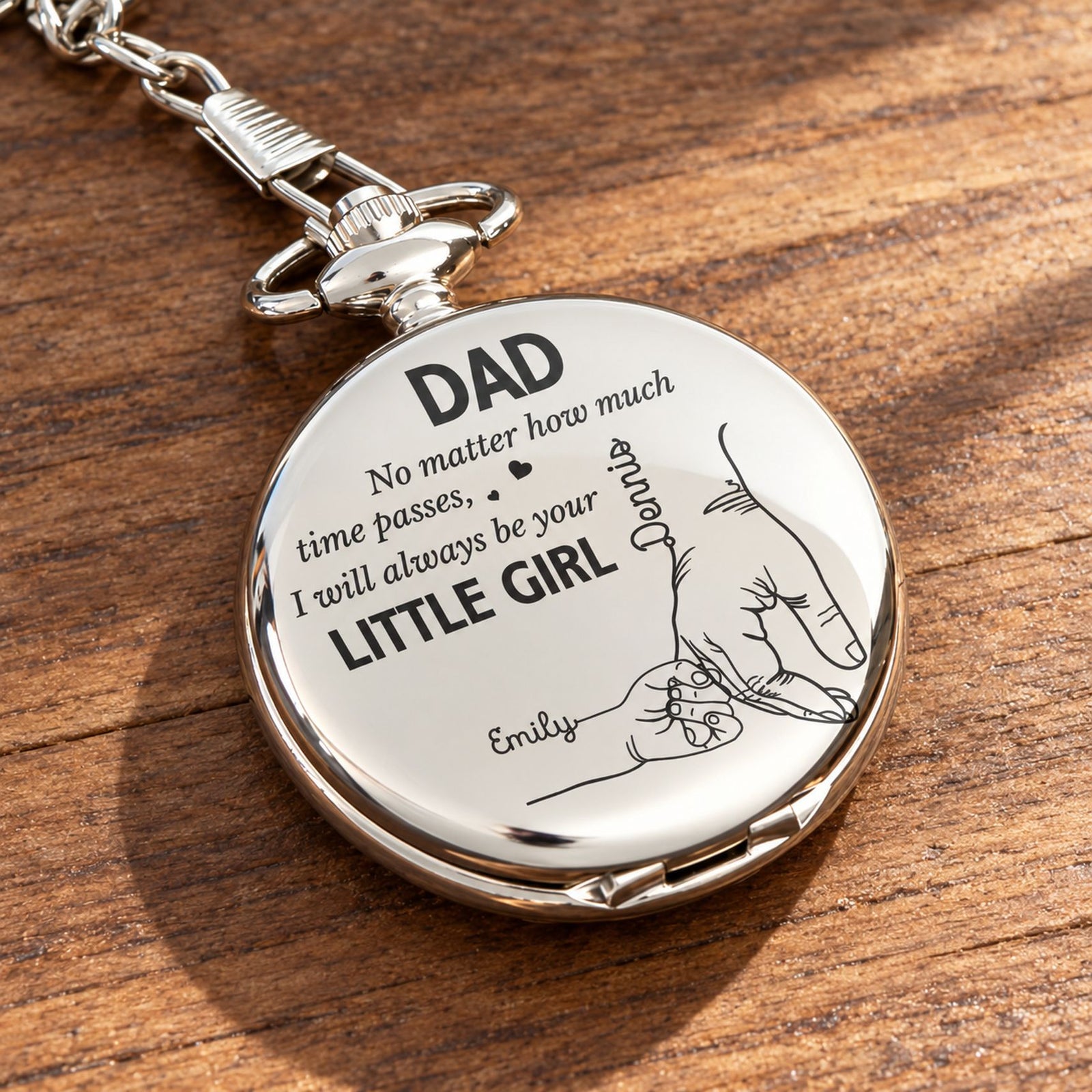 Close-up of engraved Dad pocket watch showing father and little girl hands illustration